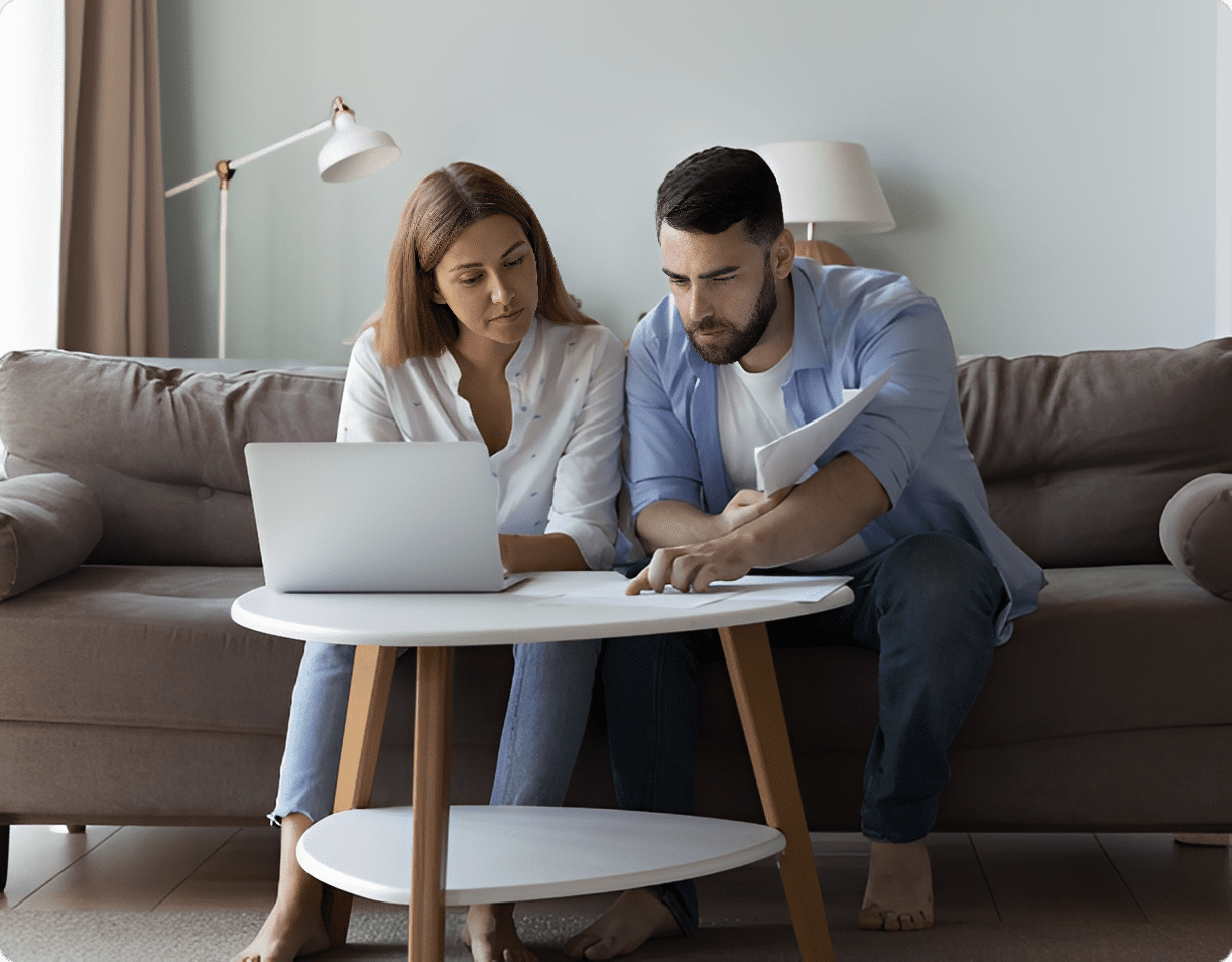 Couple reviewing bills on laptop