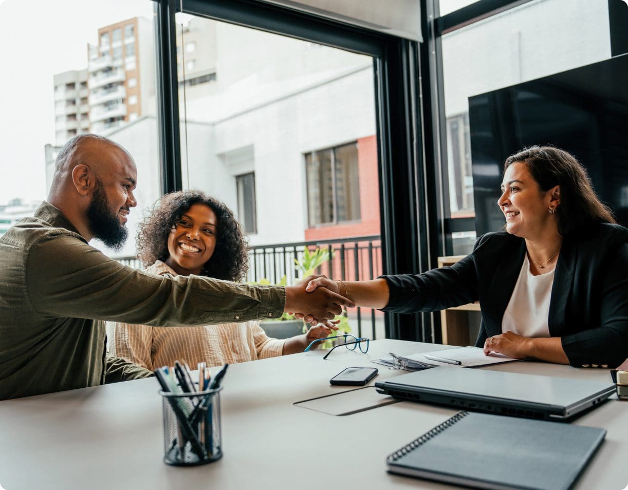 Couple shaking hands with financial advisor