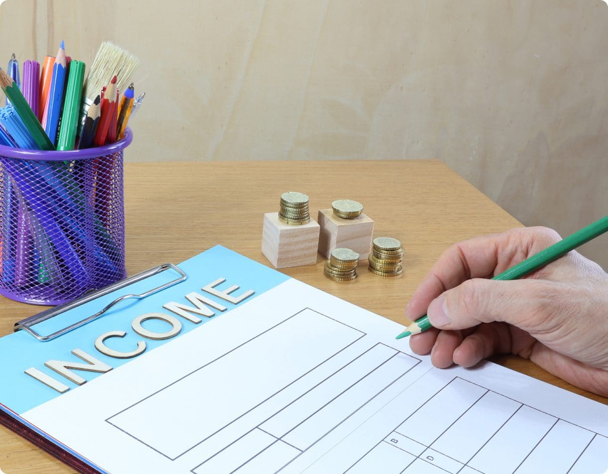 Person filling out a welcome form with colorful pens nearby.